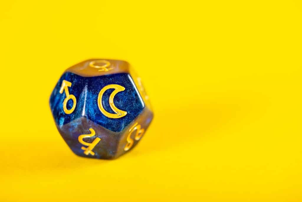 Astrology Dice with symbol of the Moon on Yellow Background