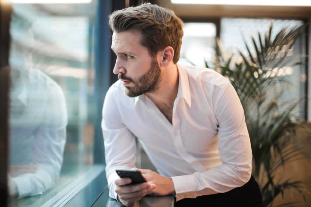 Texting guy sitting at table