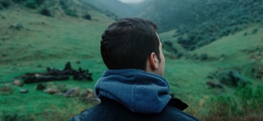 Crop image of man looking on the mountain