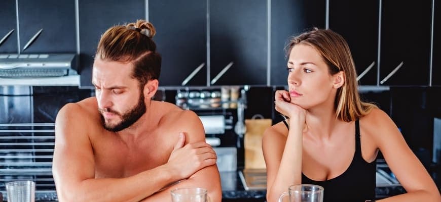 Man ignoring the woman beside him by keeping his attention to other thing.