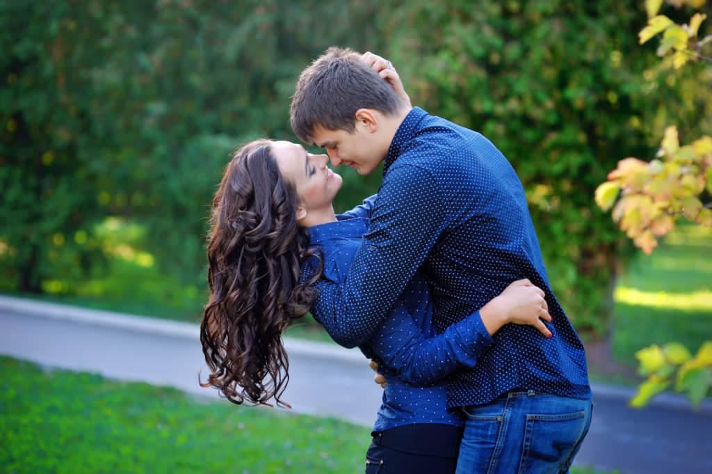 couple man and woman kissing in the park.