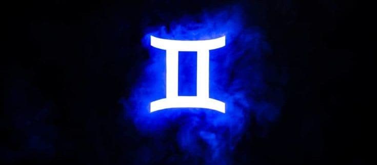 Blue illuminated Gemini zodiac sign with colorful smoke on background