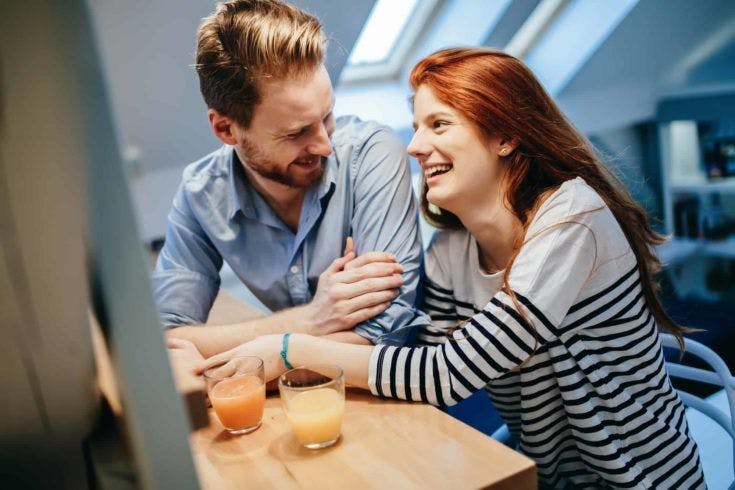 Couple in love talking smiling at home while being truly happy