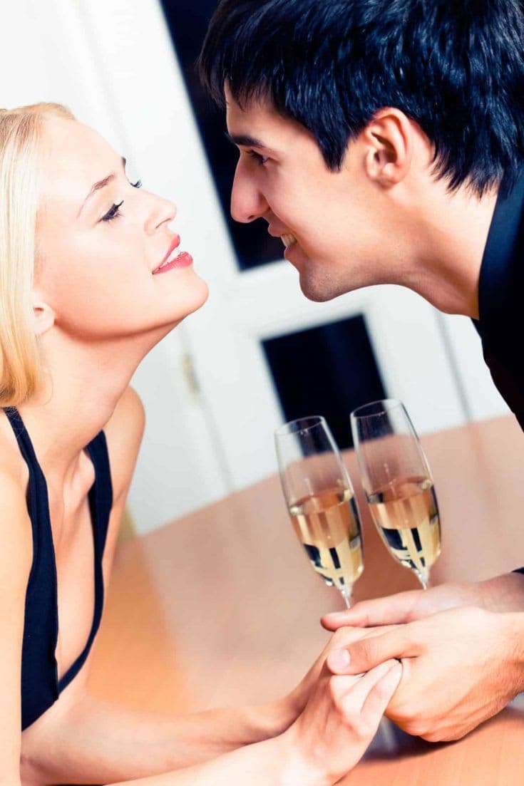 Amorous couple on romantic date or celebrating together at restaurant