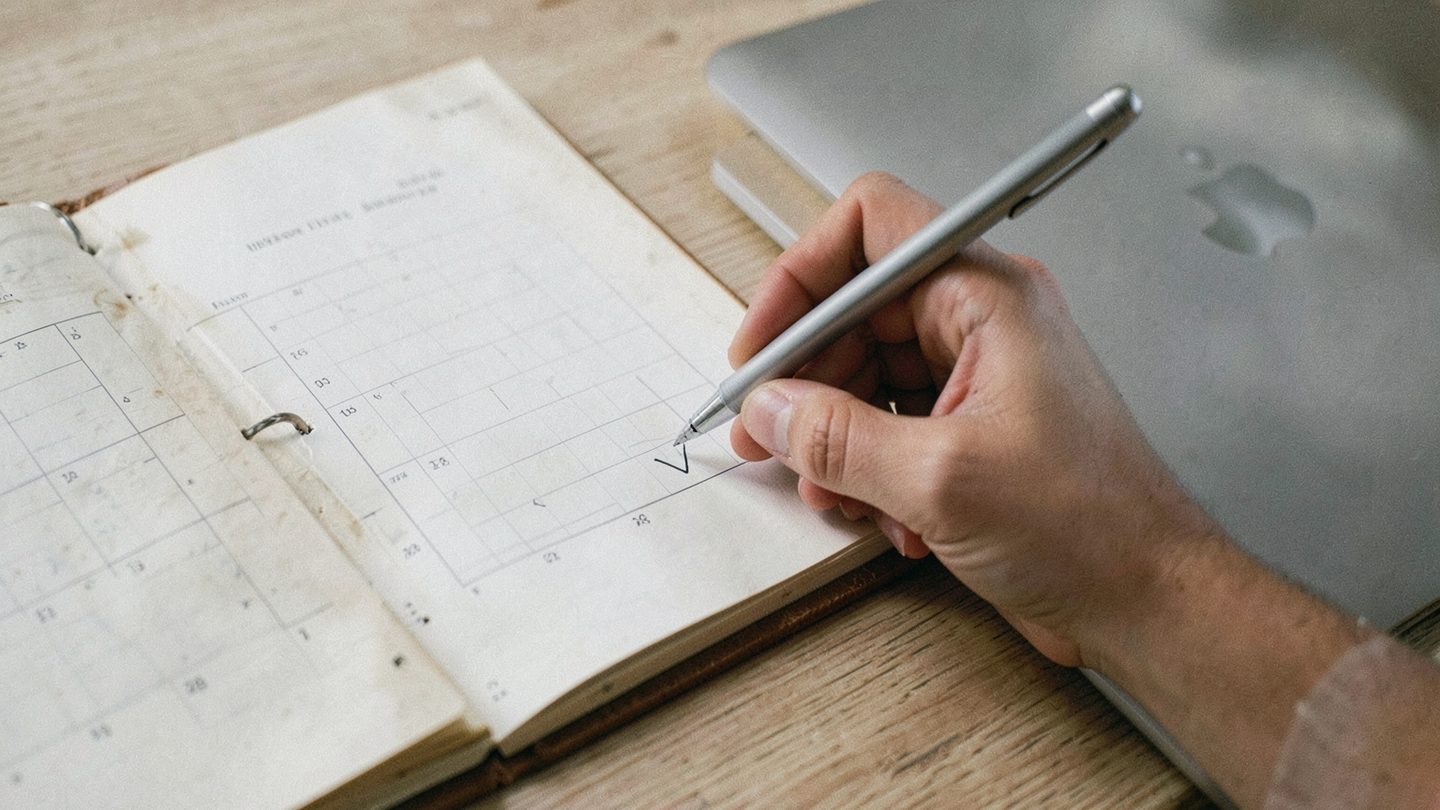 Close editorial image of a checklist beside a calendar for Scorpio season prep
