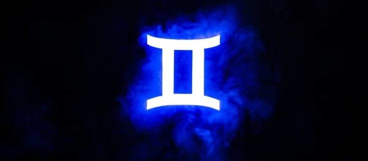 Blue illuminated Gemini zodiac sign with colorful smoke on background